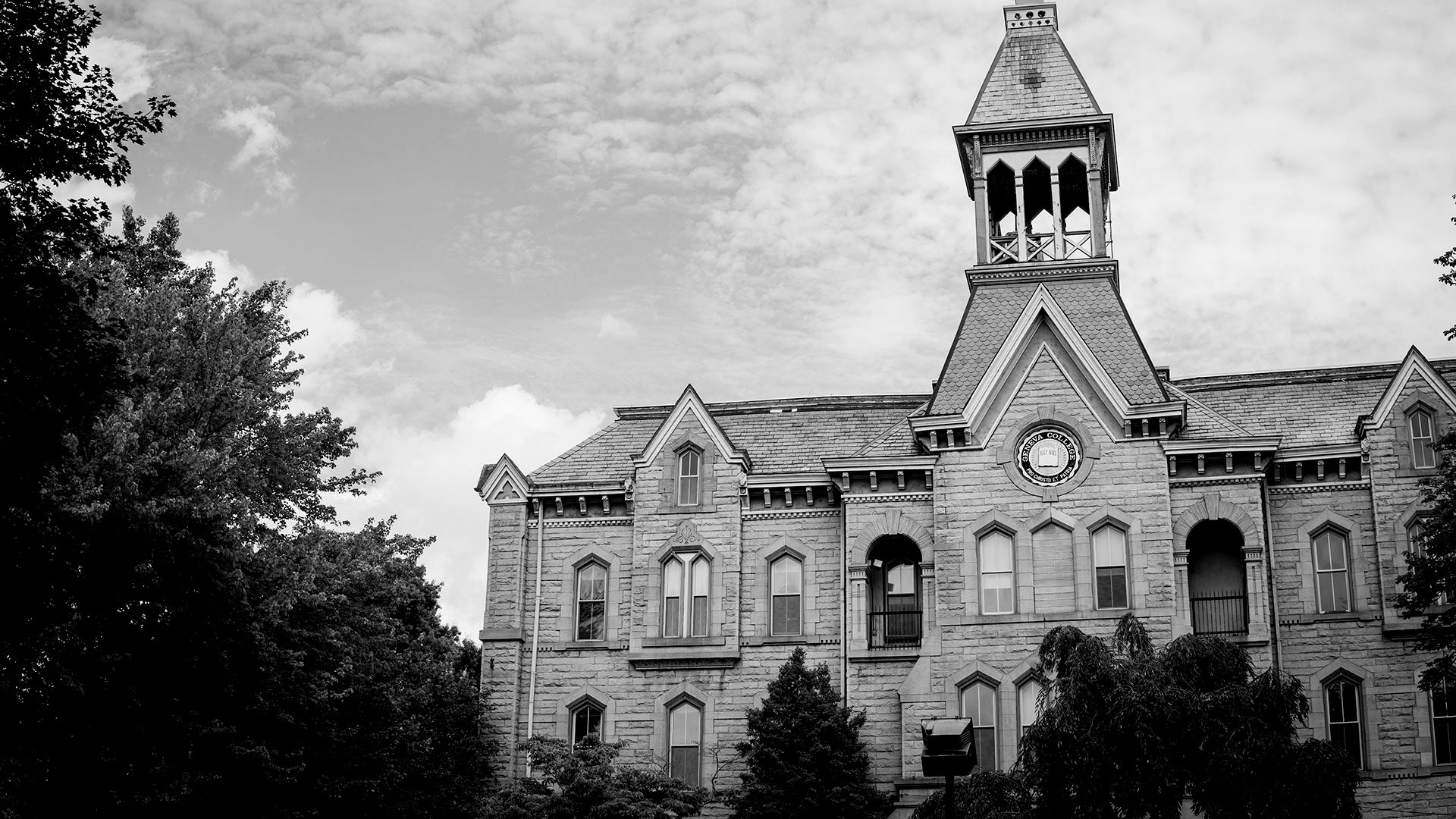 Black and white photograph of a large, historic building on Geneva's Campus with a prominent clock tower.